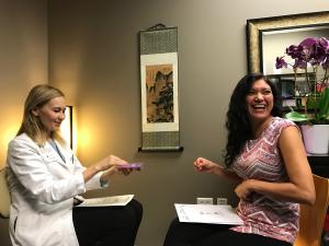 A happy student receiving Reiki certificate from Dr. Danilychev