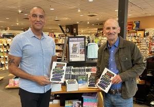 Two man standing in front of their in store book display
