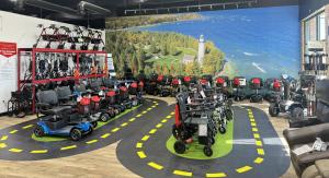 Photo of the Inside, the showroom. It is well stocked with power chairs, scooters, lift chairs, a test track and mural.