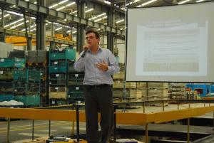 Mr. Eduardo Correa giving a presentation at a manufacturing plant