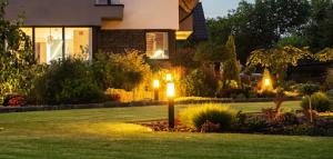  Modern LED garden light posts provide stunning landscape lighting, illuminating a beautifully landscaped residential backyard garden and enhancing its aesthetic appeal and functionality.