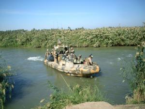 Boat with soldiers on a river