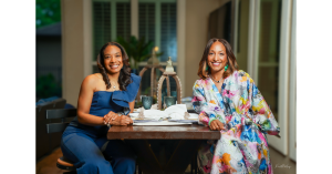 Cashid Beverage Co-Founders Taia Rashid and Daphane Carter seated left to right at a high top patio table