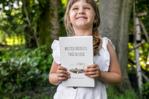 Image of Adorable Little Girl Holding a Copy of Mr. Deedle's Tree House