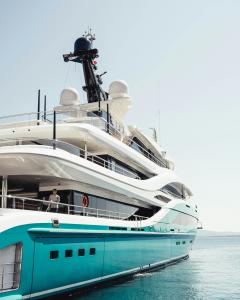 The side of a superyacht as it sails out to sea