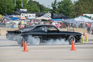 A muscle car with smoking tires coming to a stop