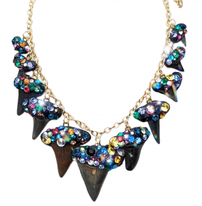 A necklace made of many shark teeth fossils covered in colorful crystals