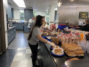 One of the LATLC Volunteers helping serve food while celebrating Independence Day with the families at the Ronald McDonald House.