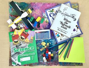 Collection of classroom materials including books and art supplies