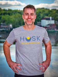 Image of executive wearing HUSK branded top