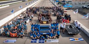 Solar Cars Surrounded by the team on the track for 2022