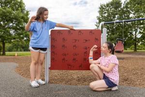 Two girls learn ASL using equipment at Warminster's new playground