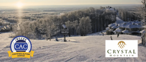 A snowy landscape of Crystal Mountain Resort with the IBCCES Certified Autism Center badge and the Crystal Mountain logo displayed.