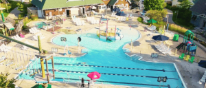 A pool at the Crystal Mountain Resort featuring a slide and a smaller slide designed for children.
