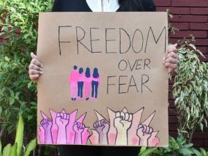 close of a handmade sign, saying "Freedom over fear"