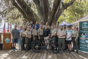 Representatives from the Florida State Parks Foundation, Florida State Parks, Cannondale Bicycles and REI Co-op's Winter Park Store gathered at Lake Louisa State Park on July 10, 2024, to celebrate 25 new e-bikes for use by park rangers across the state.
