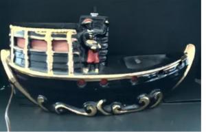 Black Americana era large porcelain lighted boat lamp, 15 inches wide by 5 inches deep, in good condition (est. $50-$150).