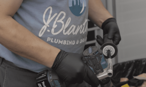  Close-up of a J. Blanton Plumbing technician using specialized tools, illustrating the company's expertise in plumbing services, repairs, and maintenance.