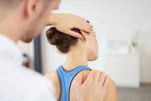 Occupational therapist aiding a patient with neck and scapula mobility - https://brookbushinstitute.com/info/occupational-therapists
