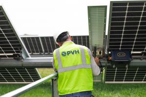 A PVH USA team member examines a solar tracker.