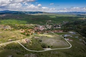 Bird's eye view of a village, featuring the charming village and the distant Corum Hattussa Ancient City in Turkey