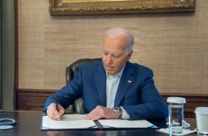 President Joe Biden is pictured signing the Maternal and Child Health Stillbirth Prevention Act of 2024.