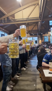 Competitors hold up their 1 liter beer steins for the annual Queen Anne Beerhall Steinholding Championship competition