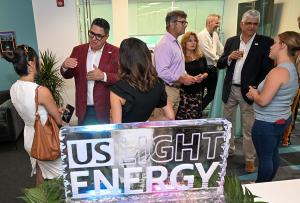 guests conversing at US light energy Summer Solstice Open House