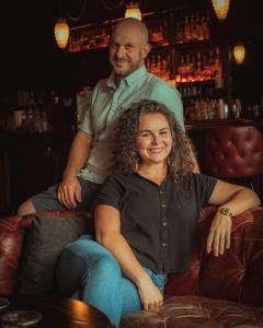 Image of Danie and Owen Powell, Neat Co-Owners sitting in the bar