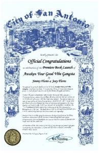 A certificate from the City of San Antonio, signed by Mayor Ron Nirenberg, congratulating Jimmy Flores and Joey Flores on the premiere book launch of “Awaken Your Good Vibe Gangsta.” The certificate features detailed blue artwork of the cityscape and nota