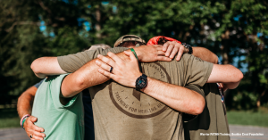 Image of a group of men hugging after completing Warrior Pathh training at Boulder Crest Foundation