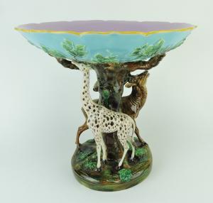 Rare and important George Jones majolica centerpiece, 14 inches tall, modeled as a giraffe and a stag eating from a tree beneath a large bowl (est. $12,000-$15,000).
