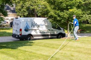 J. Blanton Plumbing technician performing maintenance work, emphasizing the company's expertise in flood control, sump pump services and basement flooding prevention services.