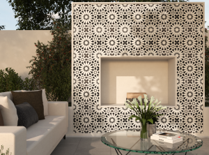 An outdoor fireplace inlaid with geometrically designed black and white cement tiles.