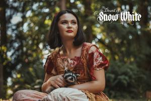 Sanae Loutsis as Snow White holding a baby raccoon in the Death of Snow White. Photo by Alley Rutzel