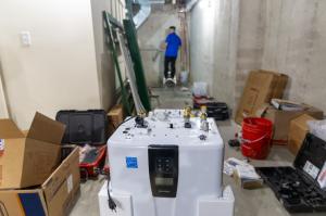 J. Blanton Plumbing technician installing a commercial water heater, highlighting the company's expertise in commercial water heaters, including tankless and continuous water heater systems.