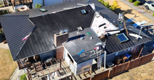 RoofSmart crew members installing a new metal roof.