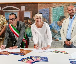     Carlo Bottani, Mayor of Curtatone, President of the Province of Mantua and Denise Kowal, founder of Avenida de Colores, President of the Sarasota Int'l Chalk Festival sign the formal agreement at a press conference in Grazie, Italy, August 14, 202