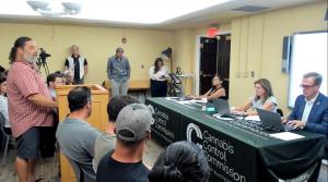 Gentleman speaks to Commissioners on a panel.