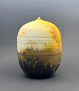 Circa 1980s closed form Anagma fired stoneware by Toshiko Takaezu (1922-2011), yellow and ochre glaze flowing down over a warm brown glaze, 7 ¼ inches tall (est. $6,000-$8,000).