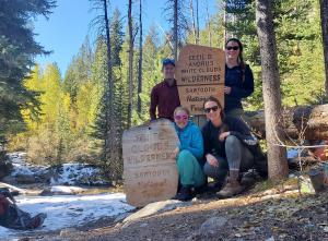 Volunteers hang sign for new (2015) White Cloud Wilderness Area