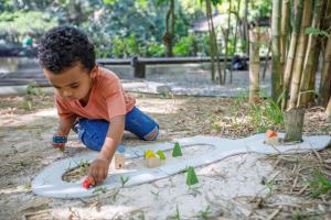 PlanToys-child plays with rubber road and rail set