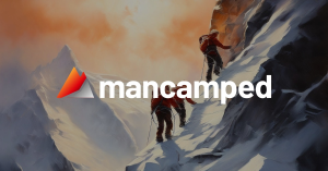 Mancamped logo overlaid on an image of men climbing a rugged mountain, symbolizing growth, challenge, and camaraderie.