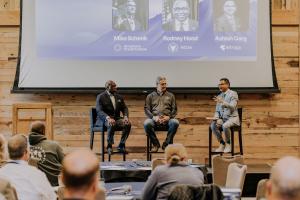 Rodney Hood (former NCUA chairman), Mike Schenk (America's Credit Unions), and Ashish Garg (Eltropy) speaking on a panel at the 2024 Eltropy Leadership Summit