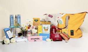 Colorful items from high-end brands laid out on a clean white table with a white background.