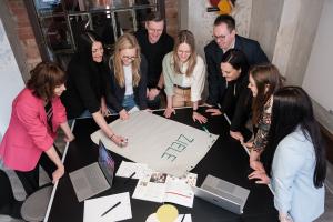 People standing at a desk an making business plans