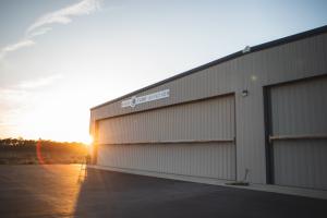 Sun rising over airplane hangar at Cape Fear Jetport