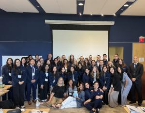 31 residents and faculty wearing FitAcademy branded fleece jackets following the close of the event.