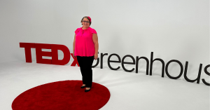 Katie Hornor, TEDx Speaker standing on stage