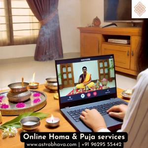 A person attending a live online Vedic puja ceremony on a laptop, with a priest performing the ritual, showing the accessibility of spiritual services through digital platforms.